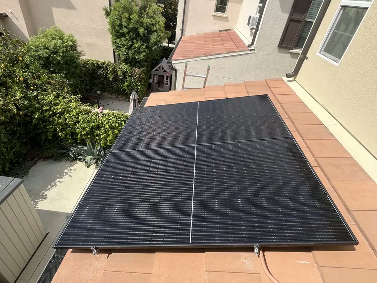 An all-black array installed on flat terracotta tile